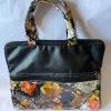 kindred-ltb-classic-b-front Front of the Kindred LTB Classic B: black leather-look top panel, a front zip pocket and a glossy leaf print in orange, yellow and grey.