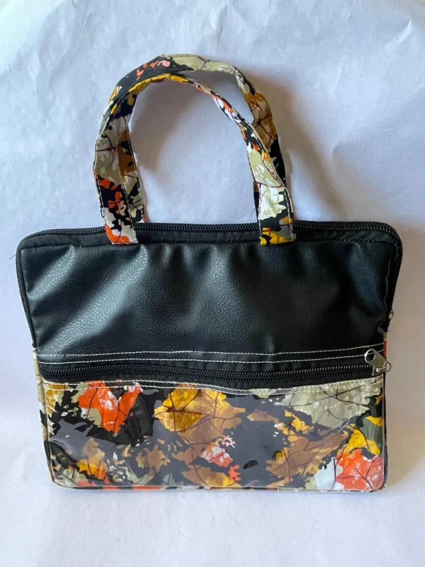 kindred-ltb-classic-b-front Front of the Kindred LTB Classic B: black leather-look top panel, a front zip pocket and a glossy leaf print in orange, yellow and grey.